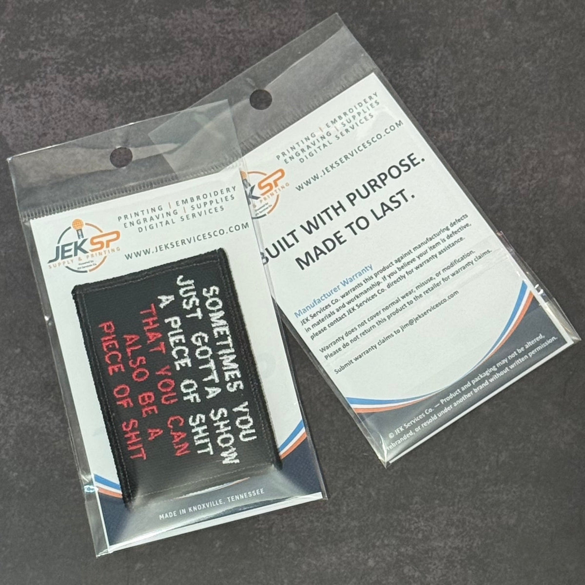 Sometimes You Just Gotta Show a Piece of Shit patch in black with white and red lettering, front and back of clear retail packaging