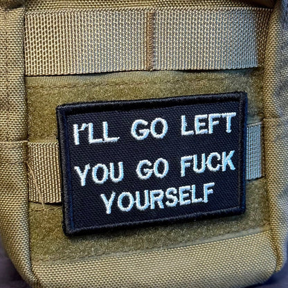 Go F*ck Yourself patch in black with white lettering, mounted on an olive backpack