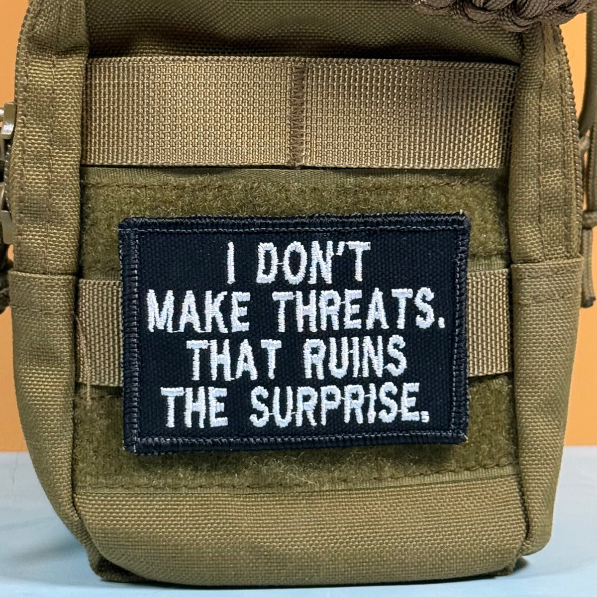 I Don't Make Threats, That Ruins The Surprise Funny Morale Patch, 2x3" | Made in USA | VELCRO® Brand Hook Backing