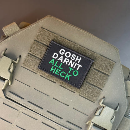 Gosh Darnit All To Heck, Polite Swearing patch in black with white and green lettering, mounted on a tan plate carrier