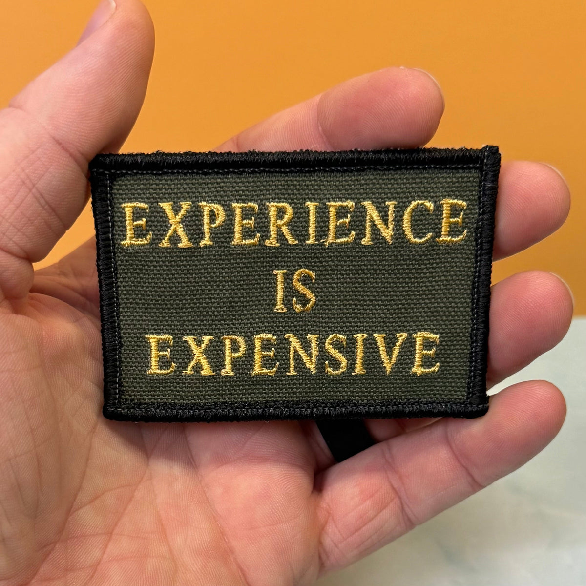 Experience Is Expensive Funny Tactical Morale Patch, 2x3" | Made in USA | VELCRO® Brand Hook Backing