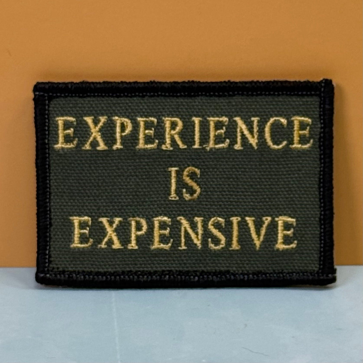 Experience Is Expensive Funny Tactical Morale Patch, 2x3" | Made in USA | VELCRO® Brand Hook Backing