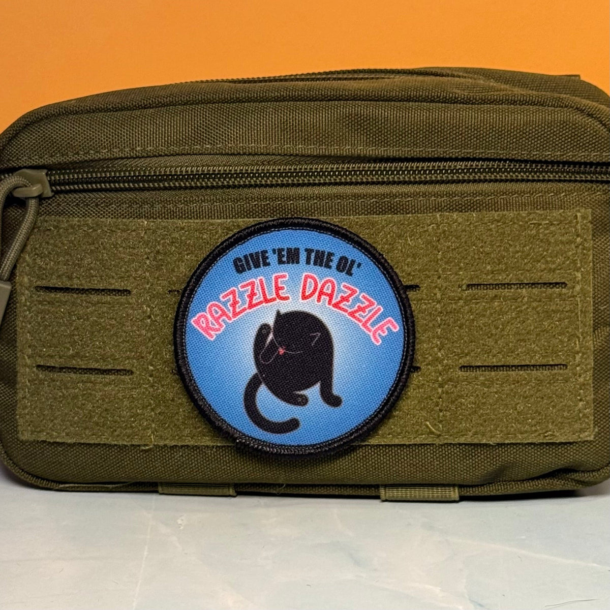 Give 'Em The Razzle Dazzle Funny Printed Morale Patch, 3" Round | VELCRO® Brand Hook Backing