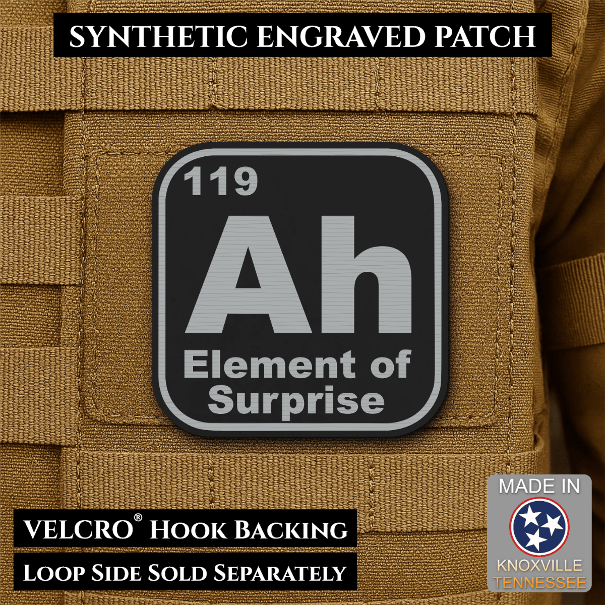 Front design and hook backing of Ah, The Element of Surprise patch in black / silver