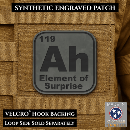 Front design and hook backing of Ah, The Element of Surprise patch in charcoal gray