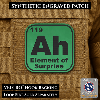 Front design and hook backing of Ah, The Element of Surprise patch in green