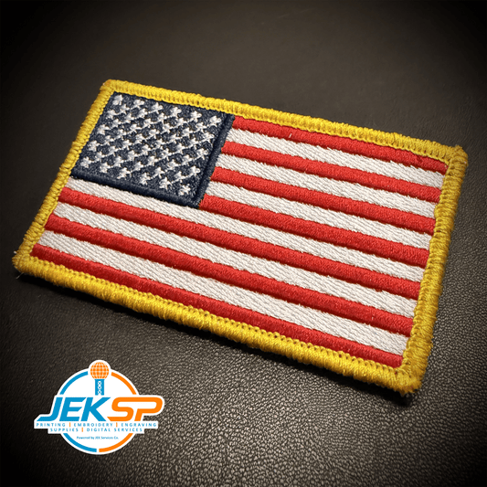 Front view of American Flag patch in red, white and blue stars and stripes with a yellow border, union on the left