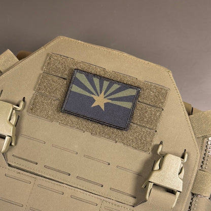 Arizona State Flag patch in subdued tan and dark blue Arizona flag with a star and radiating rays, mounted on a tan plate carrier