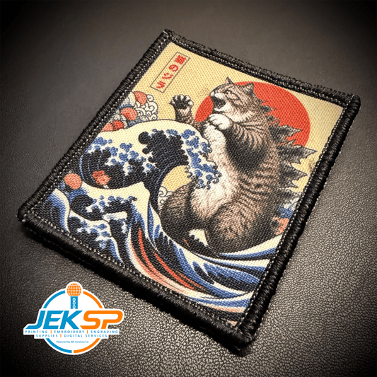 Front view of Catzilla patch in blue, cream and red with a giant tabby cat above ocean waves