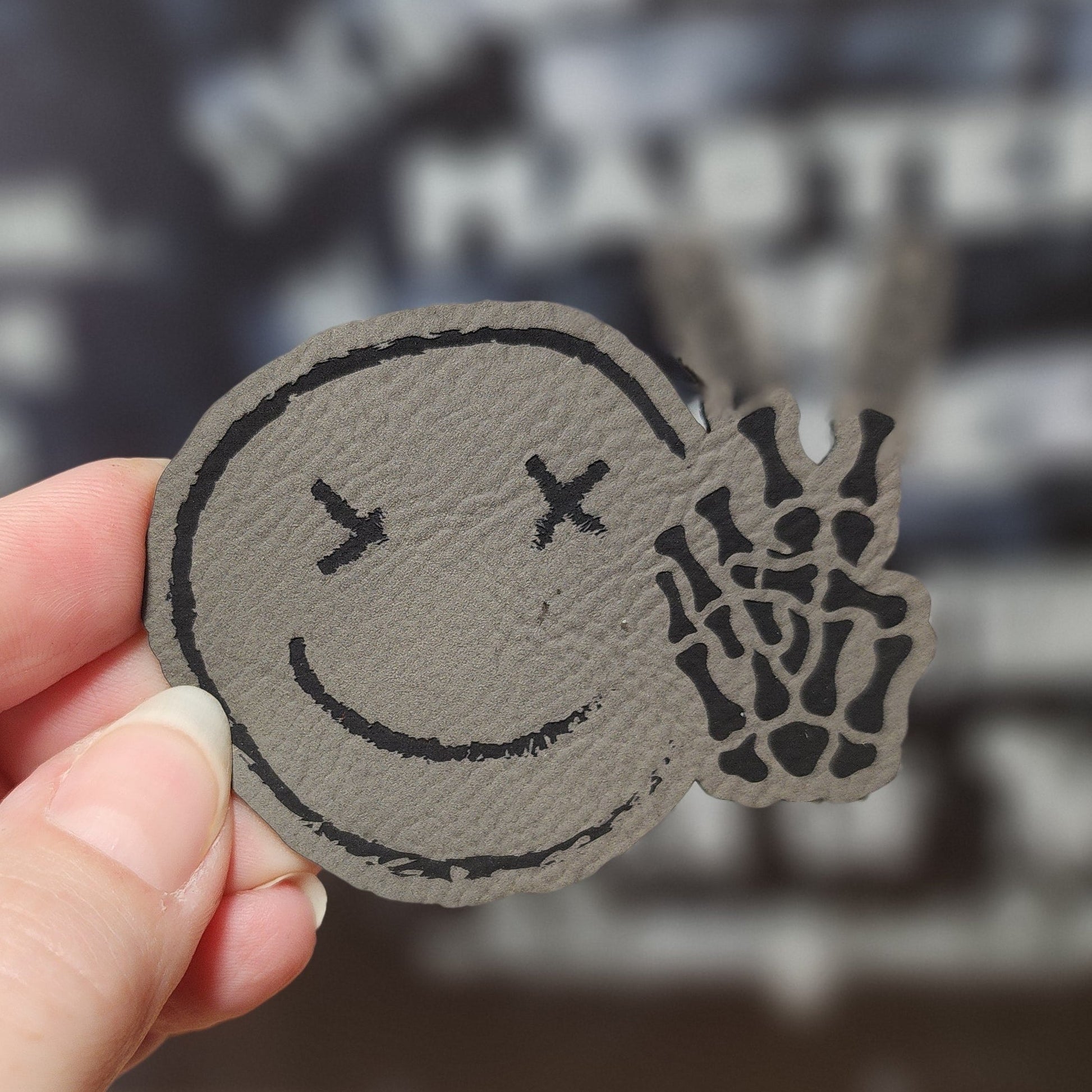 Chilling Smiley with Bones (Grey) Engraved Leatherette Hat Patch - MR01 - LoneStar Adhesive