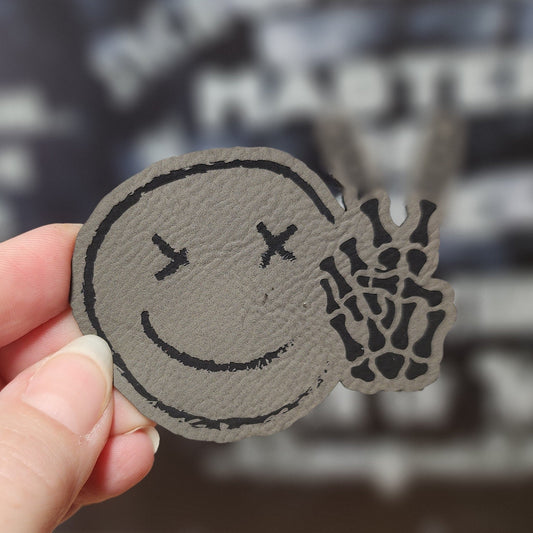 Chilling Smiley with Bones (Grey) Engraved Leatherette Hat Patch - MR01 - LoneStar Adhesive