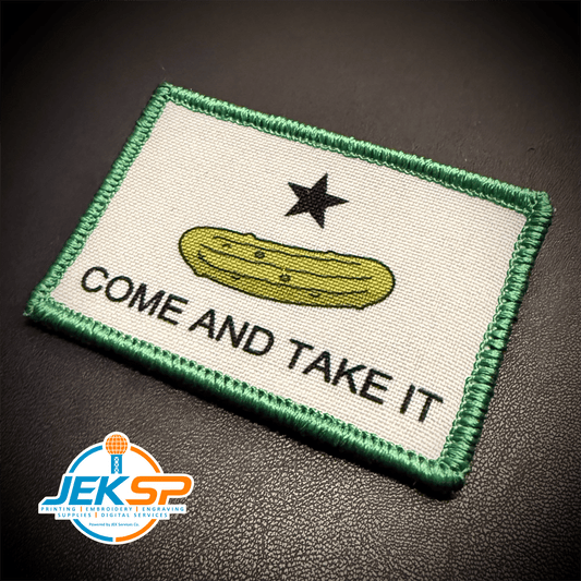 Front view of Come and Take It Pickle patch in white with a green pickle, black star and green border