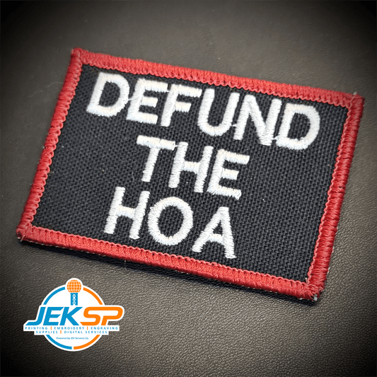Front view of Defund the HOA patch in black with white lettering and a red border