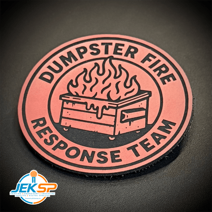 Front view of Dumpster Fire Response Team patch in coral pink with a black flaming dumpster illustration and lettering