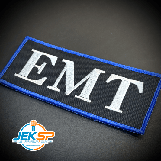 Front view of EMT ID Plate Carrier patch in black with white EMT lettering and a blue border