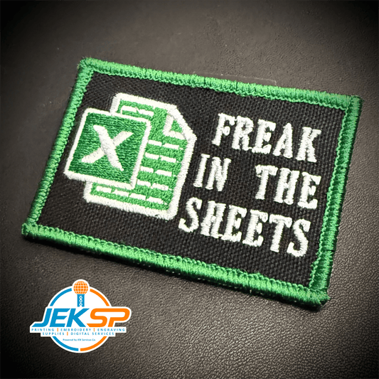 Front view of Freak In The Sheets patch in black with a green spreadsheet icon, white lettering and green border