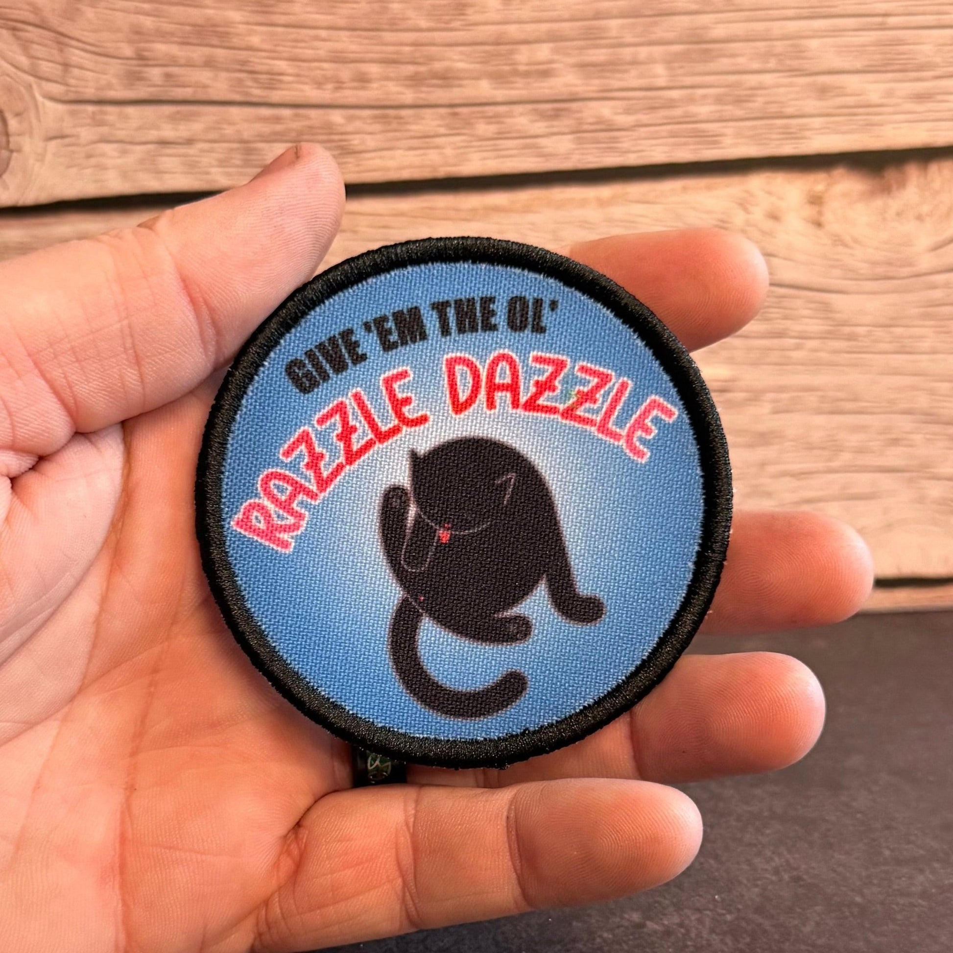 Give 'Em The Razzle Dazzle Funny Morale Patch | Made in USA | VELCRO® Brand Hook Backing - LoneStar Adhesive