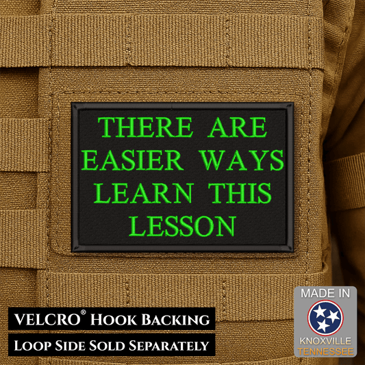 Front design and hook backing of Hard Life Lessons patch in black with green lettering