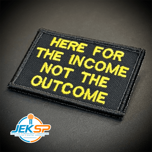 Front view of Here For The Income, Not The Outcome patch in black with yellow lettering
