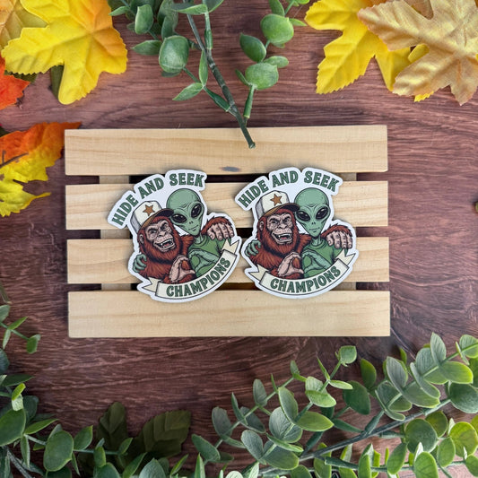 Hide and Seek Champions (Big Foot & Alien) | UV Printed Leather Hat Patch - LoneStar Adhesive