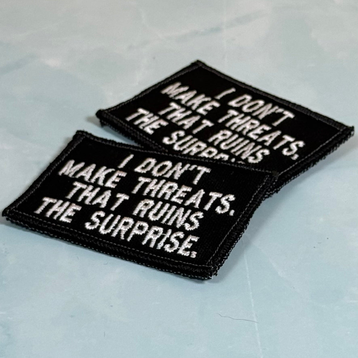 I Don't Make Threats, That Ruins The Surprise Funny Morale Patch, 2x3" | Made in USA | VELCRO® Brand Hook Backing - LoneStar Adhesive