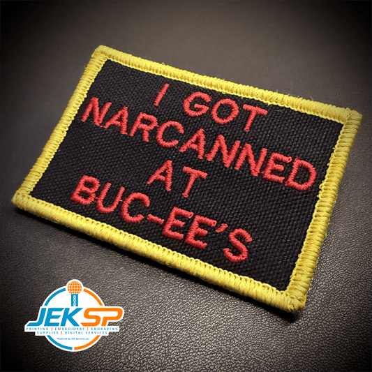 Front view of I Got Narcanned At Buc-ee's patch in black with red lettering and a yellow border