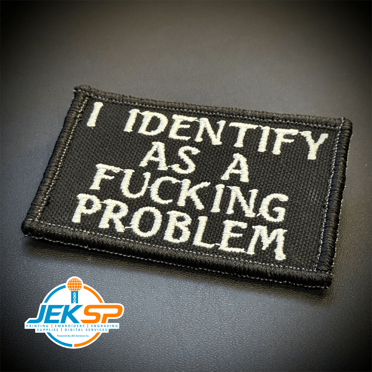 Front view of I Identify As The Problem patch in black with white lettering