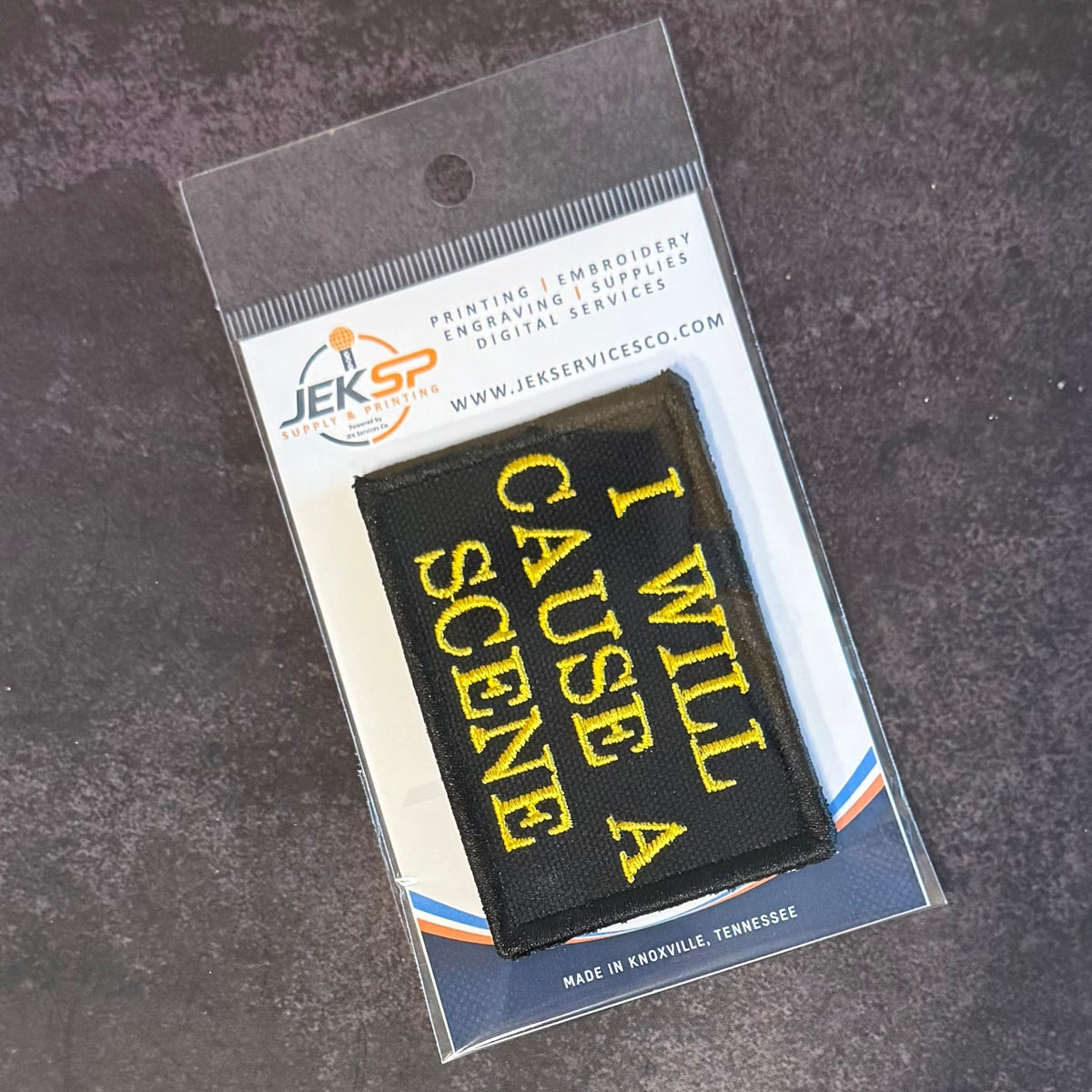 I Will Cause A Scene patch in black with yellow lettering, in clear retail packaging
