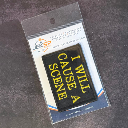 I Will Cause A Scene patch in black with yellow lettering, in clear retail packaging