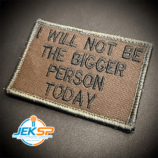 Front view of I Will Not Be The Bigger Person Today patch in brown with black lettering and a tan border