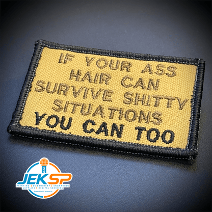 Front view of If Your Ass Hair Can Survive patch in tan with dark lettering