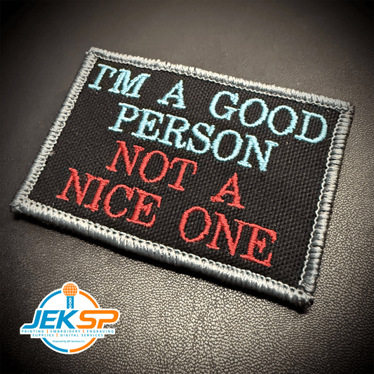 Front view of I'm A Good Person, Not A Nice One patch in black with pale blue and red lettering