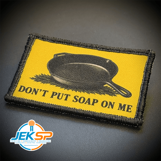 Front view of Iron Skillet Gadsden, Don't Put Soap On Me patch in yellow with a black skillet silhouette and lettering