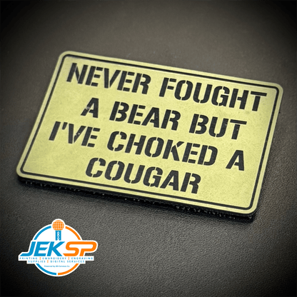 Front view of I’ve Choked A Cougar patch in tan with black lettering