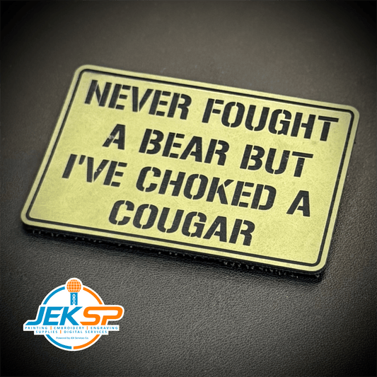 Front view of I’ve Choked A Cougar patch in tan with black lettering