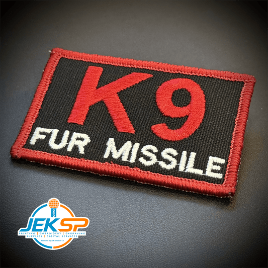 Front view of K-9 Fur Missile patch in black with red K9 and border and white FUR MISSILE lettering