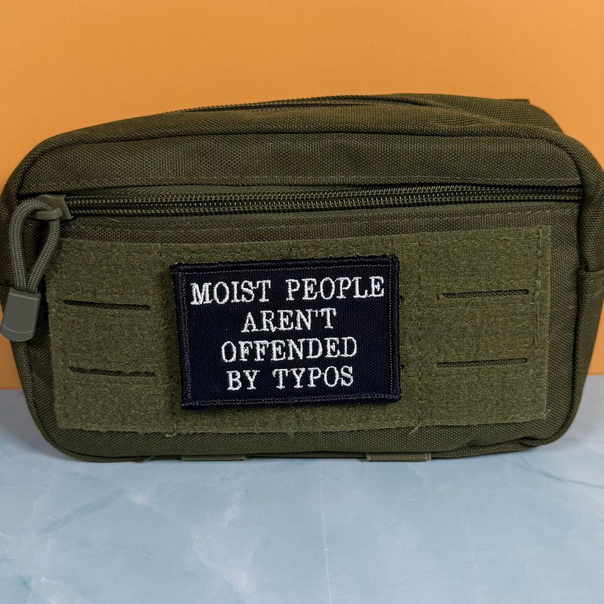 Moist People Aren’t Offended by Typos Funny Morale Patch, 2x3" | Made in USA | VELCRO® Brand Hook Backing - LoneStar Adhesive