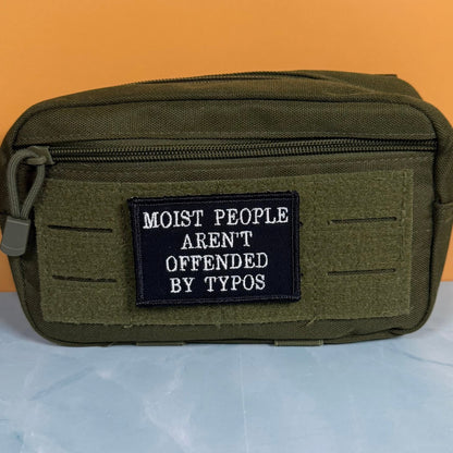 Moist People Aren’t Offended by Typos Funny Morale Patch, 2x3" | Made in USA | VELCRO® Brand Hook Backing - LoneStar Adhesive