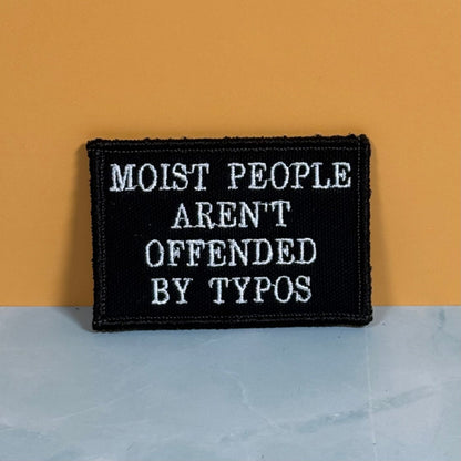 Moist People Aren’t Offended by Typos Funny Morale Patch, 2x3" | Made in USA | VELCRO® Brand Hook Backing - LoneStar Adhesive