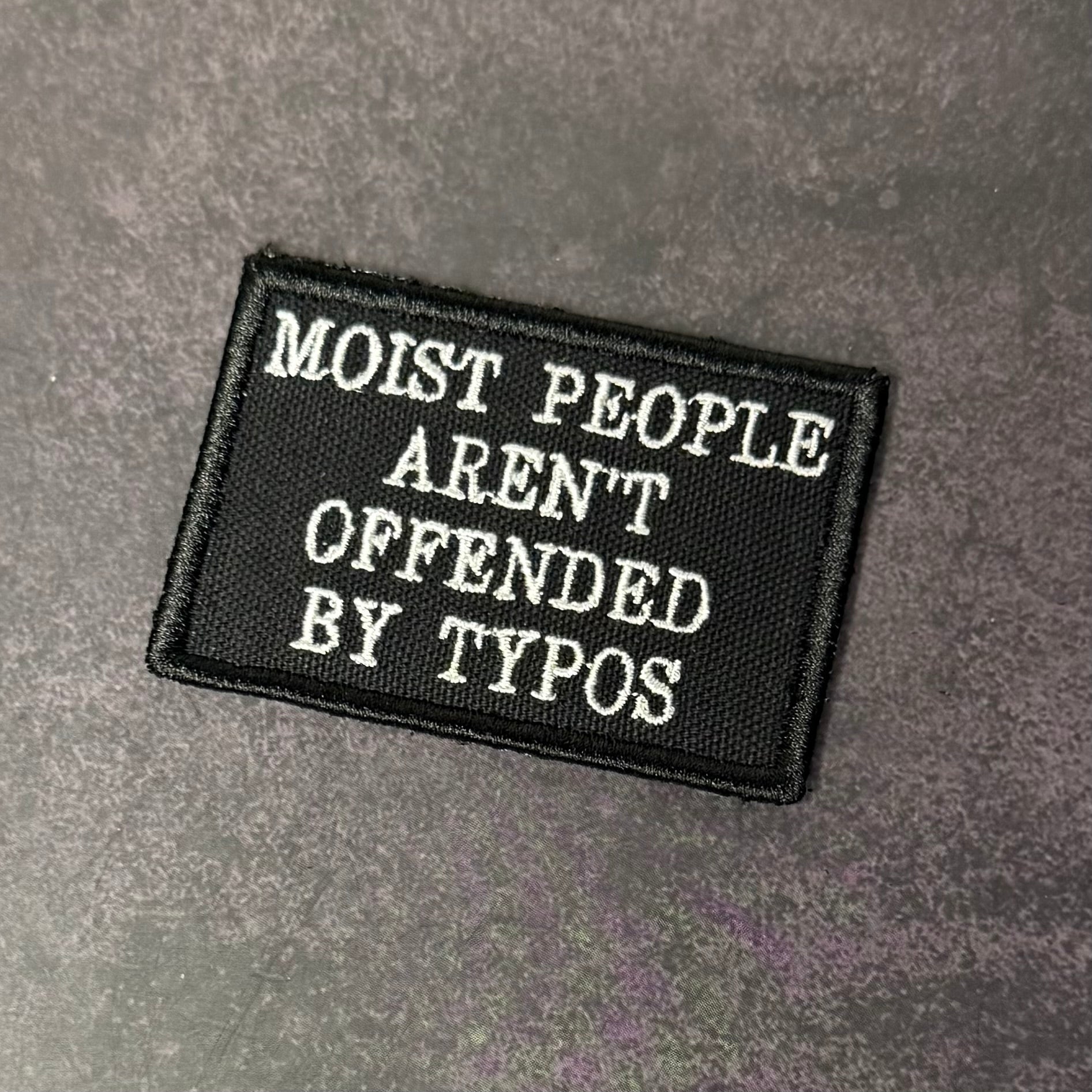 Moist People Aren’t Offended by Typos Funny Morale Patch | Made in USA | VELCRO® Brand Hook Backing - LoneStar Adhesive