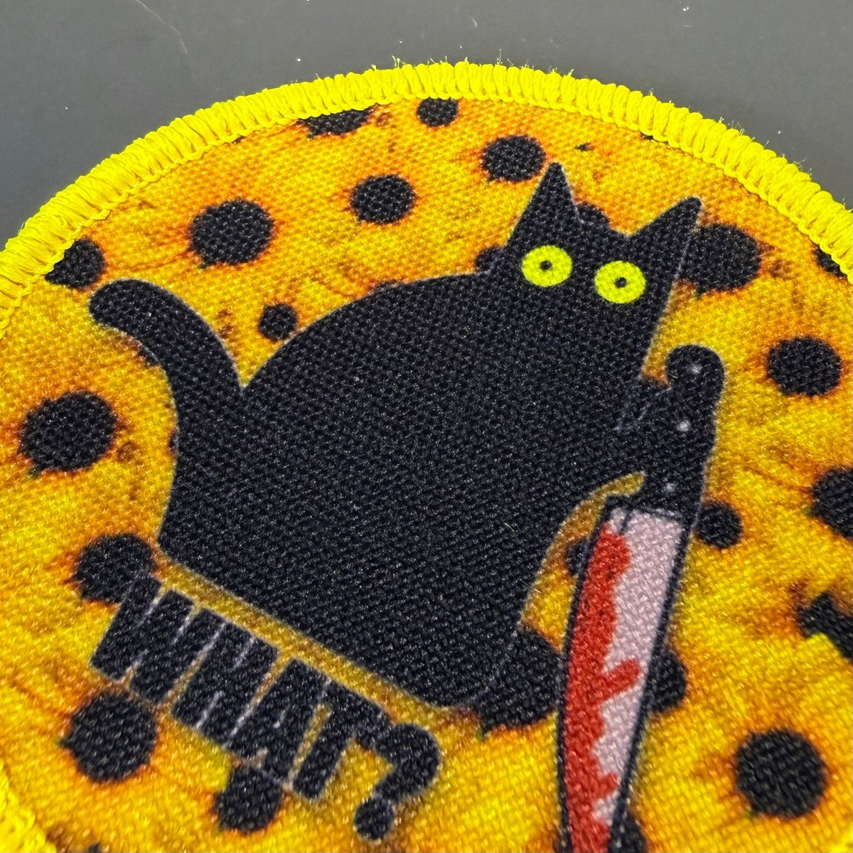 Murder Cat & Sunflowers patch in yellow with a black cat, sunflowers and a red knife, close-up of embroidery
