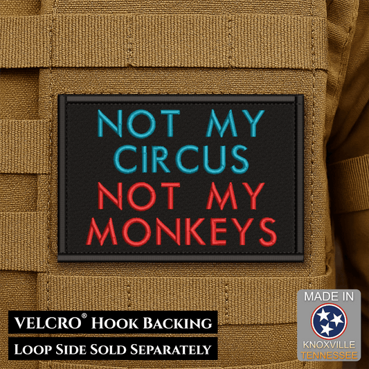 Front design and hook backing of Not My Circus, Not My Monkeys patch in black with teal and red lettering