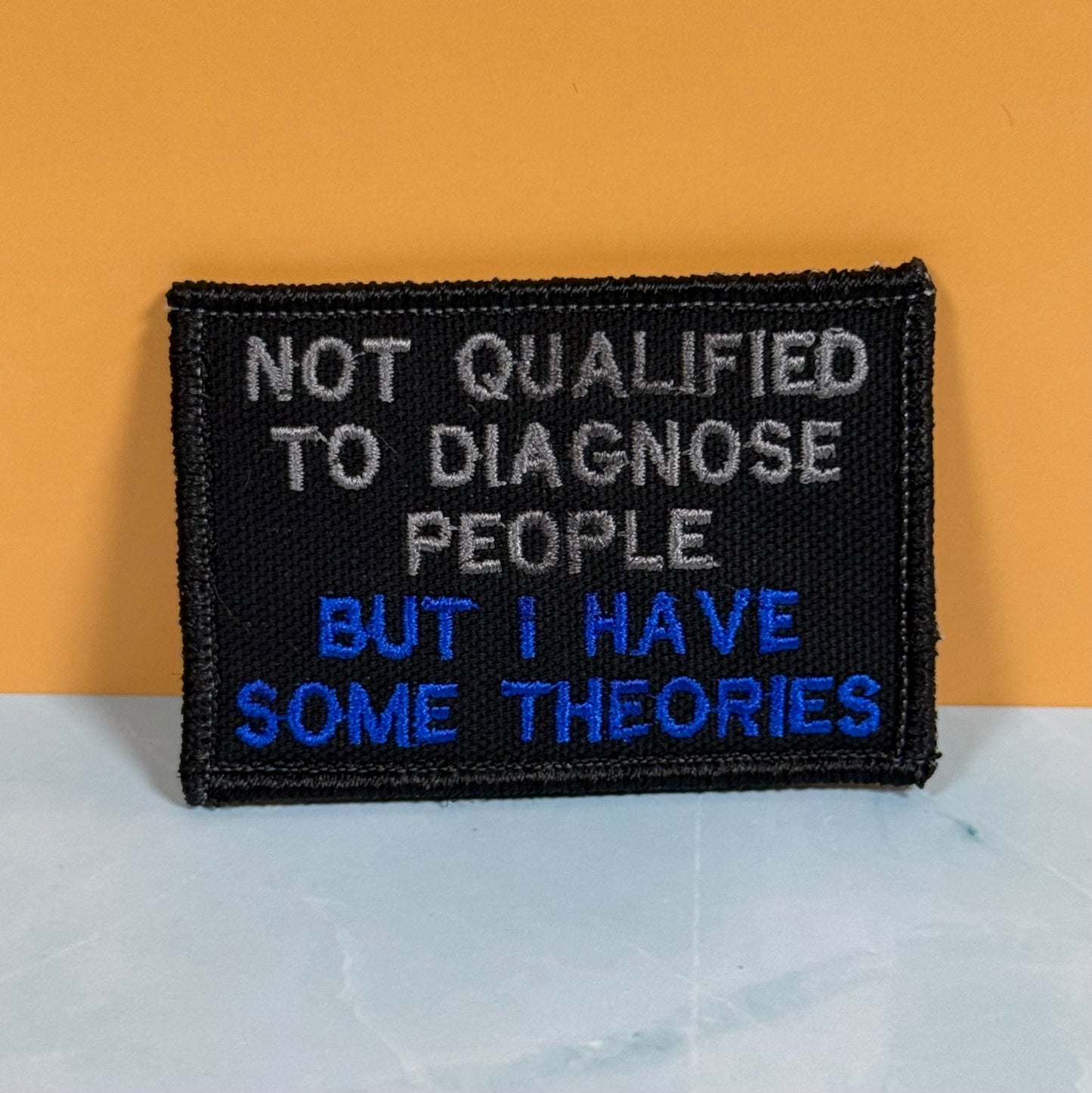 Not Qualified to Diagnose People, But I Have Theories Funny Morale Patch, 2x3" | Made in USA | VELCRO® Brand Hook Backing - LoneStar Adhesive