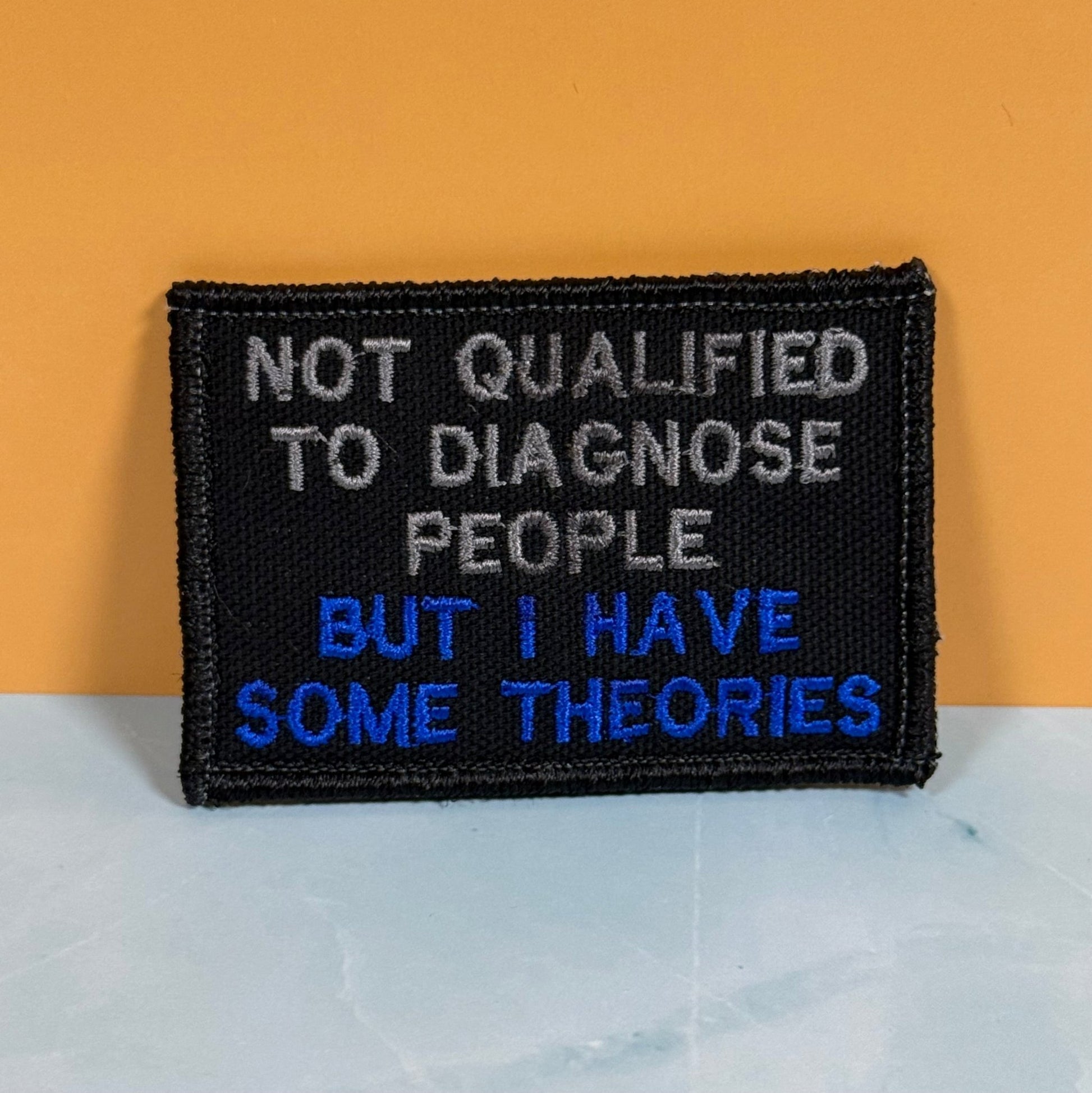 Not Qualified to Diagnose People, But I Have Theories Funny Morale Patch, 2x3" | Made in USA | VELCRO® Brand Hook Backing - LoneStar Adhesive