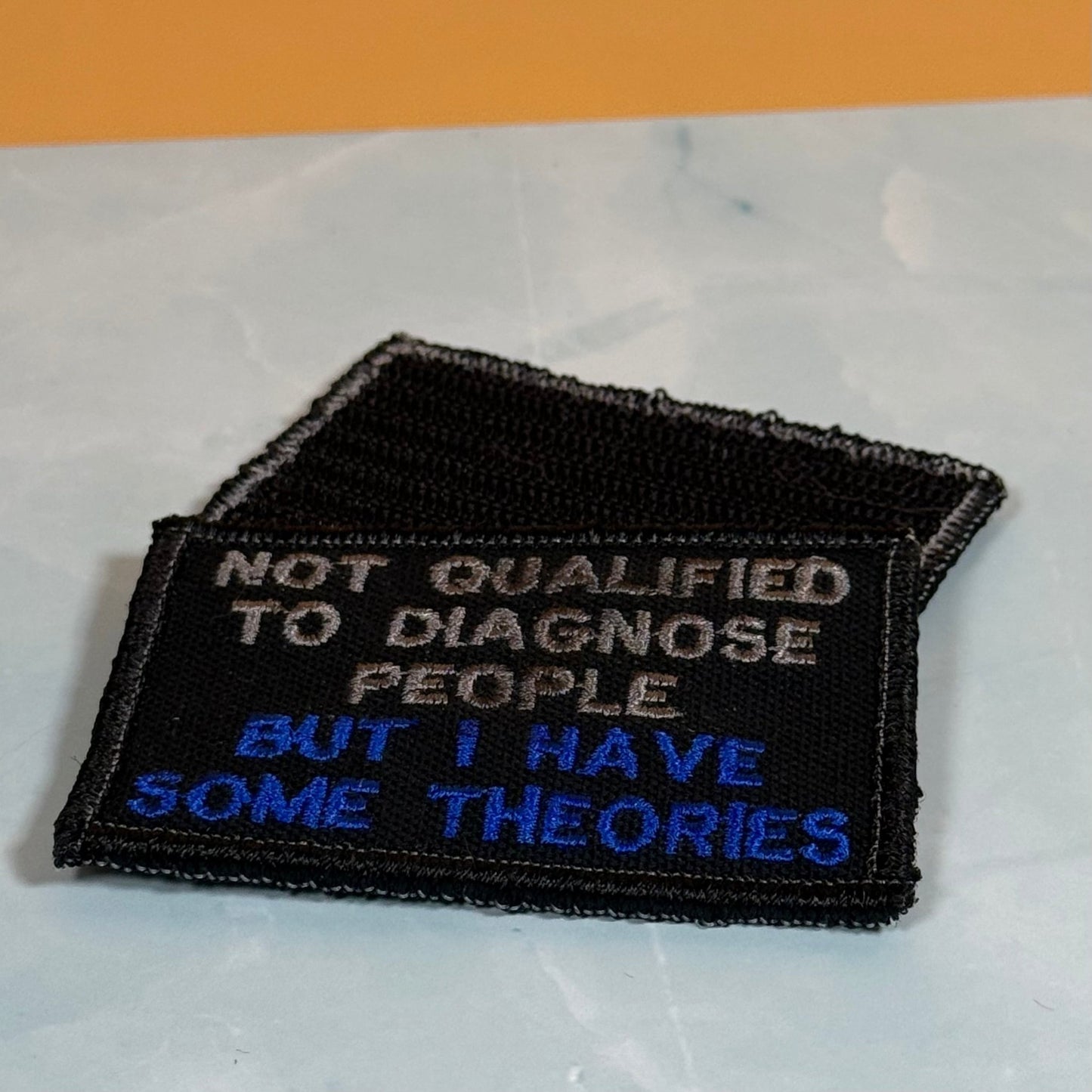 Not Qualified to Diagnose People, But I Have Theories Funny Morale Patch, 2x3" | Made in USA | VELCRO® Brand Hook Backing - LoneStar Adhesive