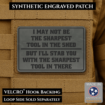 Front design and hook backing of Not The Sharpest Tool In The Shed patch in charcoal gray