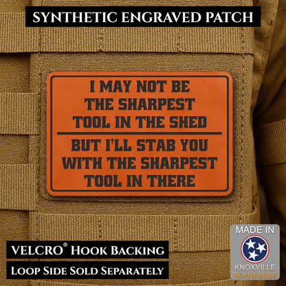 Front design and hook backing of Not The Sharpest Tool In The Shed patch in orange