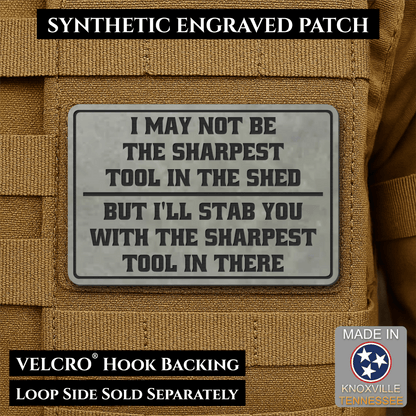 Front design and hook backing of Not The Sharpest Tool In The Shed patch in flint gray