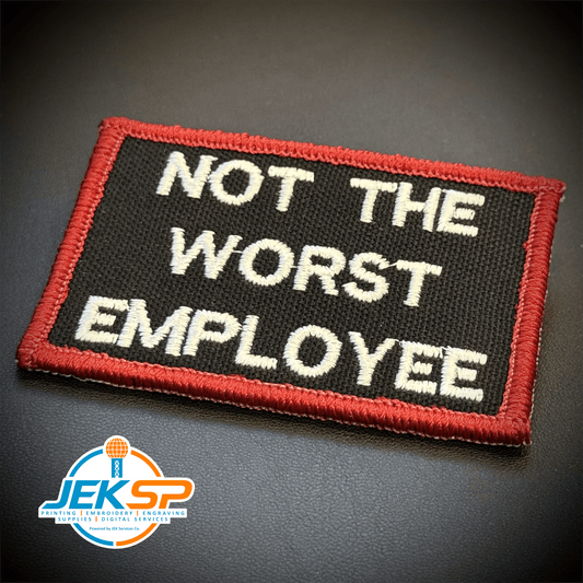 Front view of Not The Worst Employee patch in black with white lettering and a red border