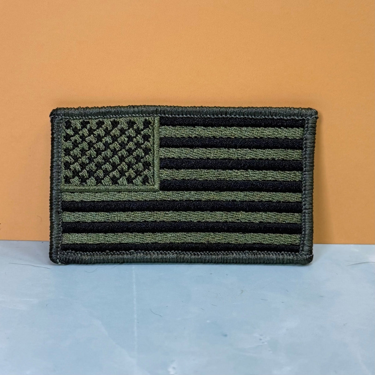 Front view of Olive OD Green Tactical American Flag patch in olive green and black stars and stripes